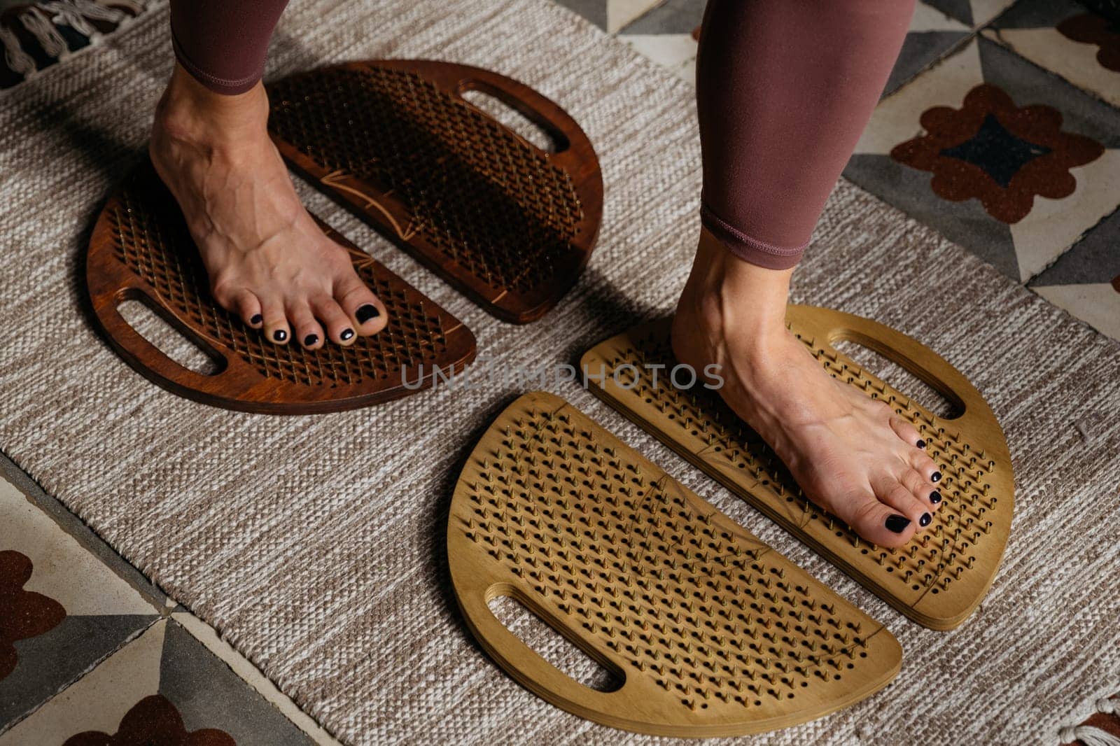 Top view of feet on different colored sadhu boards against diverse textured mats.