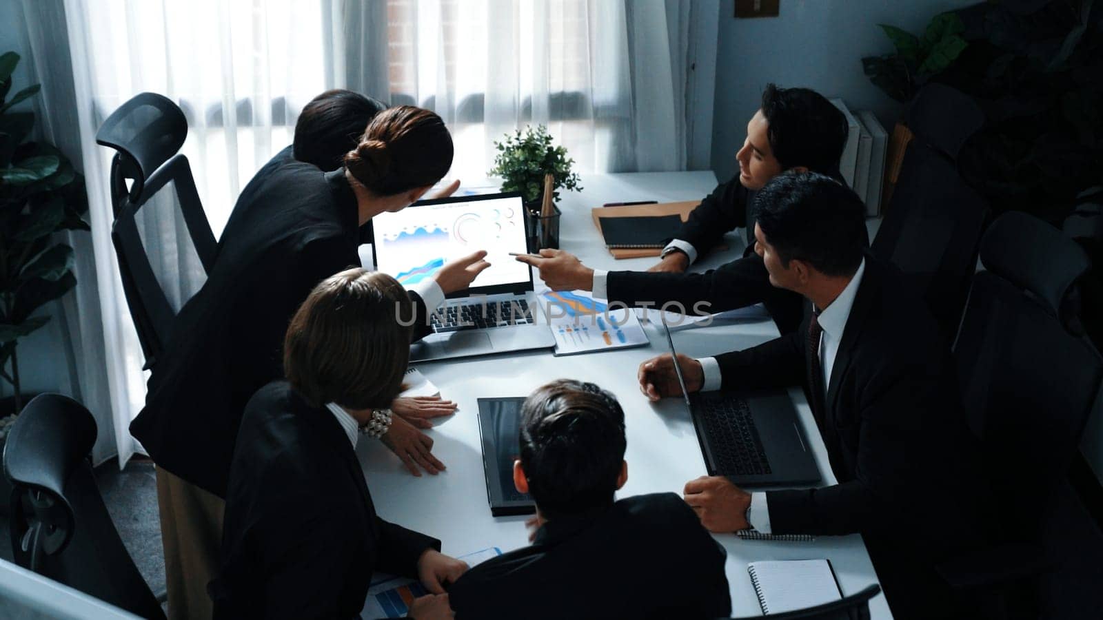 Top view of skilled analytic analysis stock market investment data at meeting. Businessman show increasing graph or financial statistic to investors at table with document and device. Directorate.