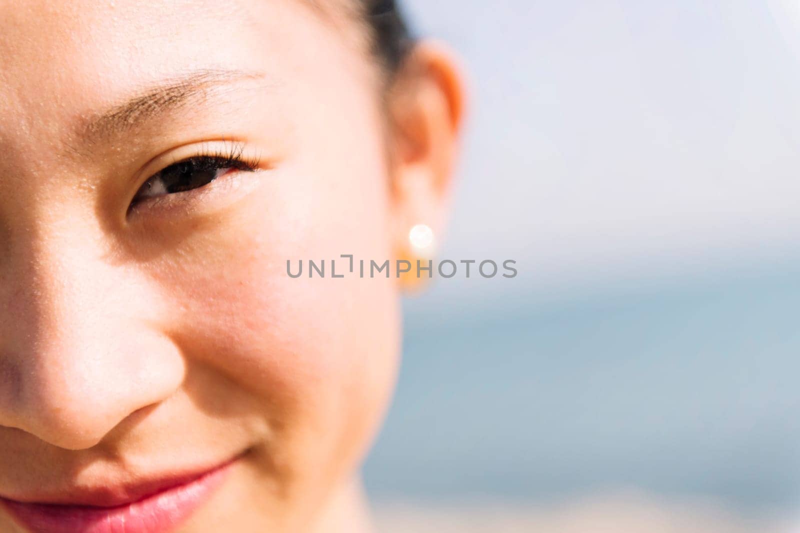 close up of the eye of asian woman smiling happy by raulmelldo