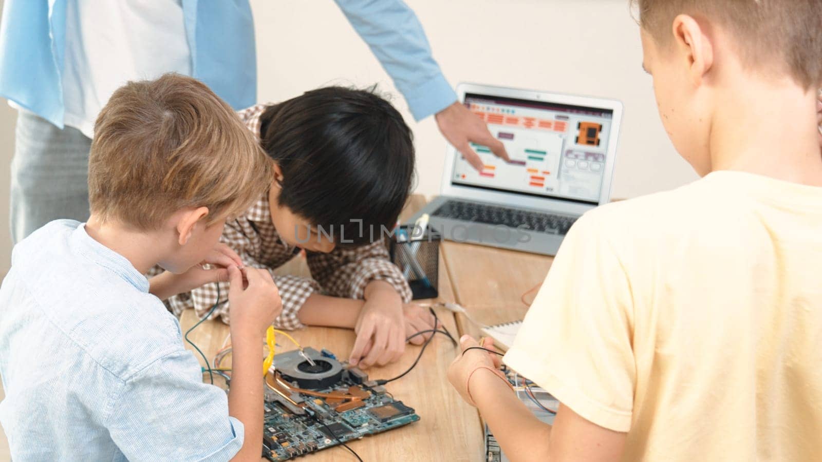 Group of diverse student working together while teacher hold tablet. Pedagogy. by biancoblue