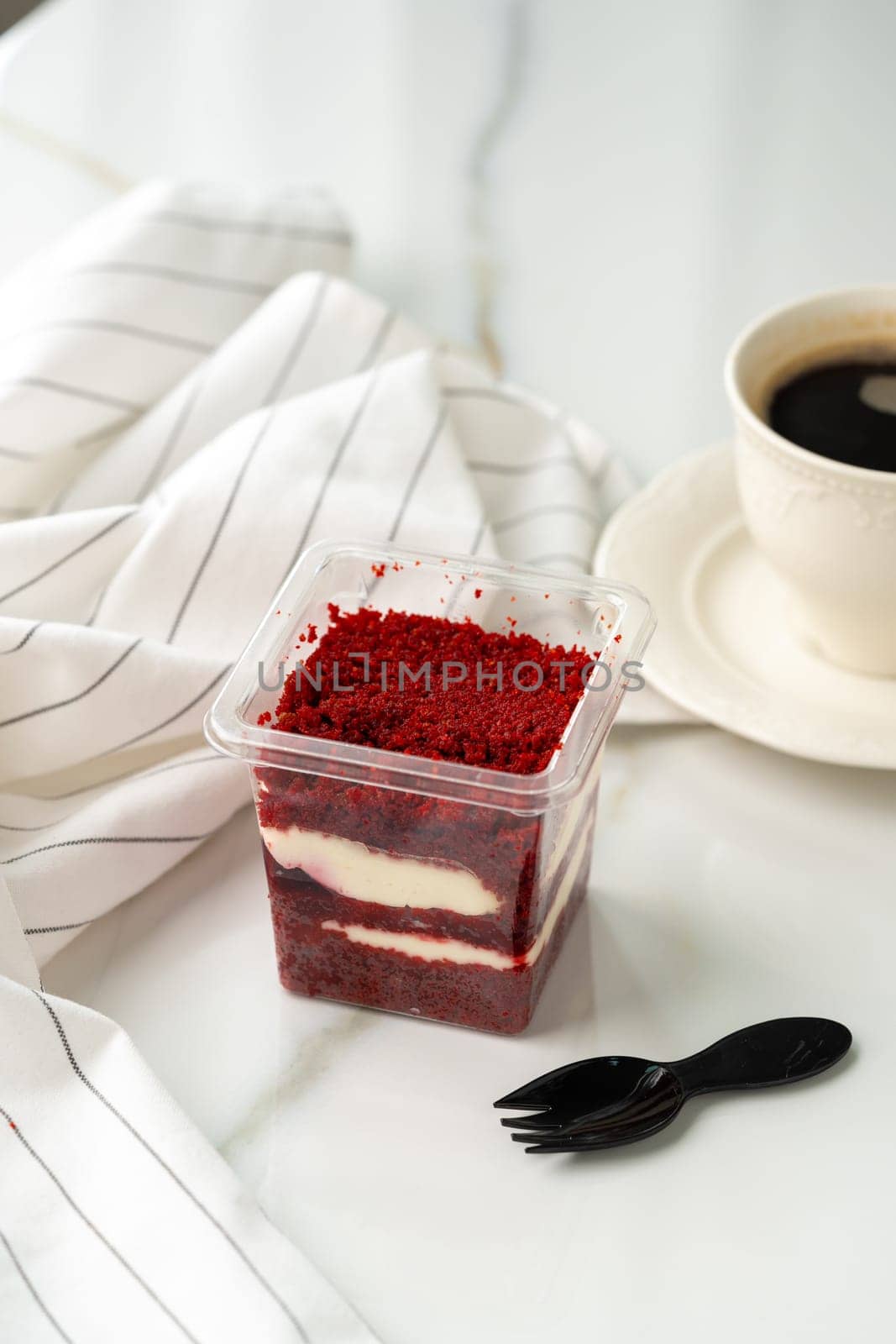 Trifle red velvet in plastic cup on table by Fabrikasimf