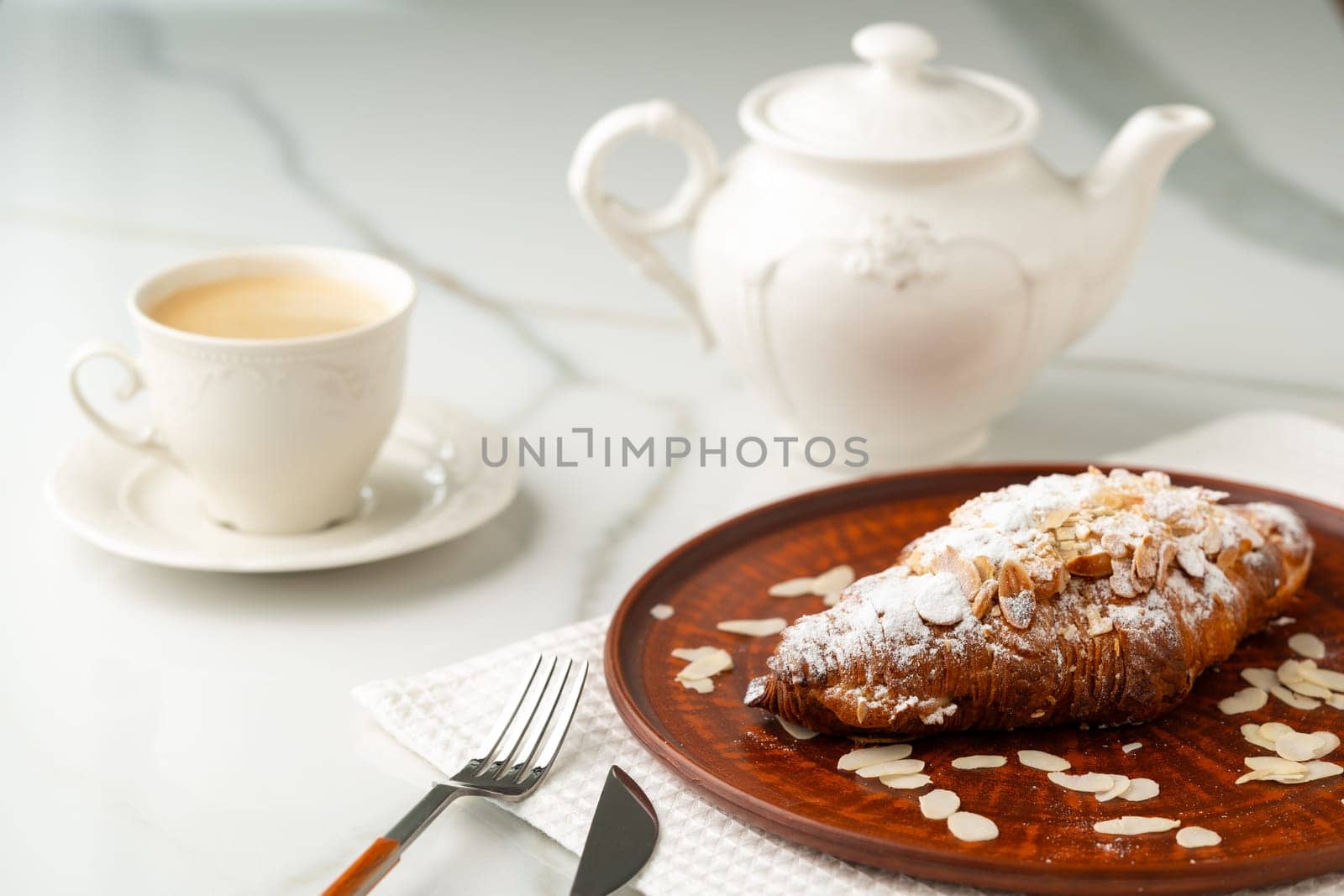 Almond Croissant on clay plate close up by Fabrikasimf