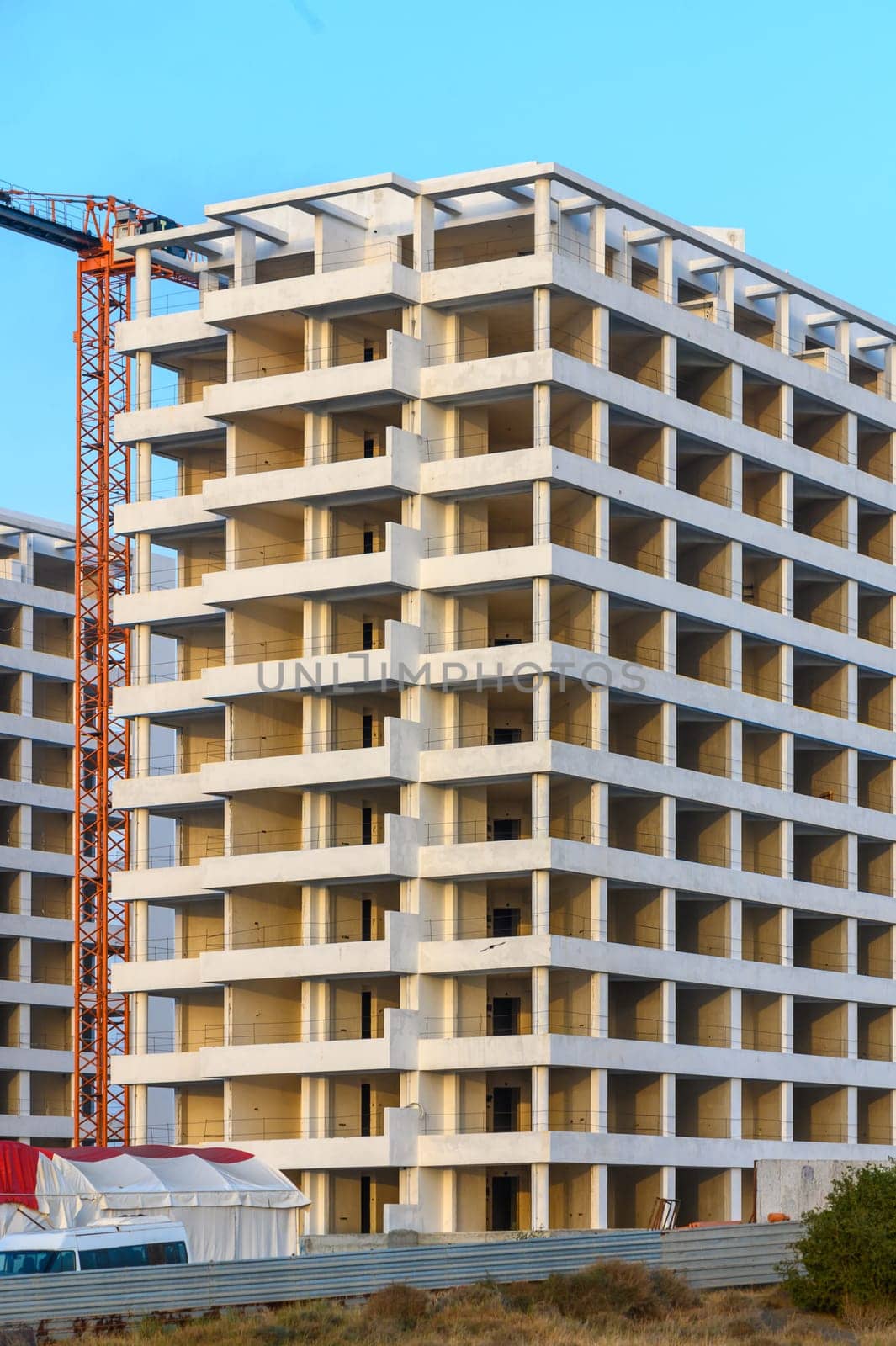 Tower cranes on the construction site of a block of flats of the monolithic residential apartment building