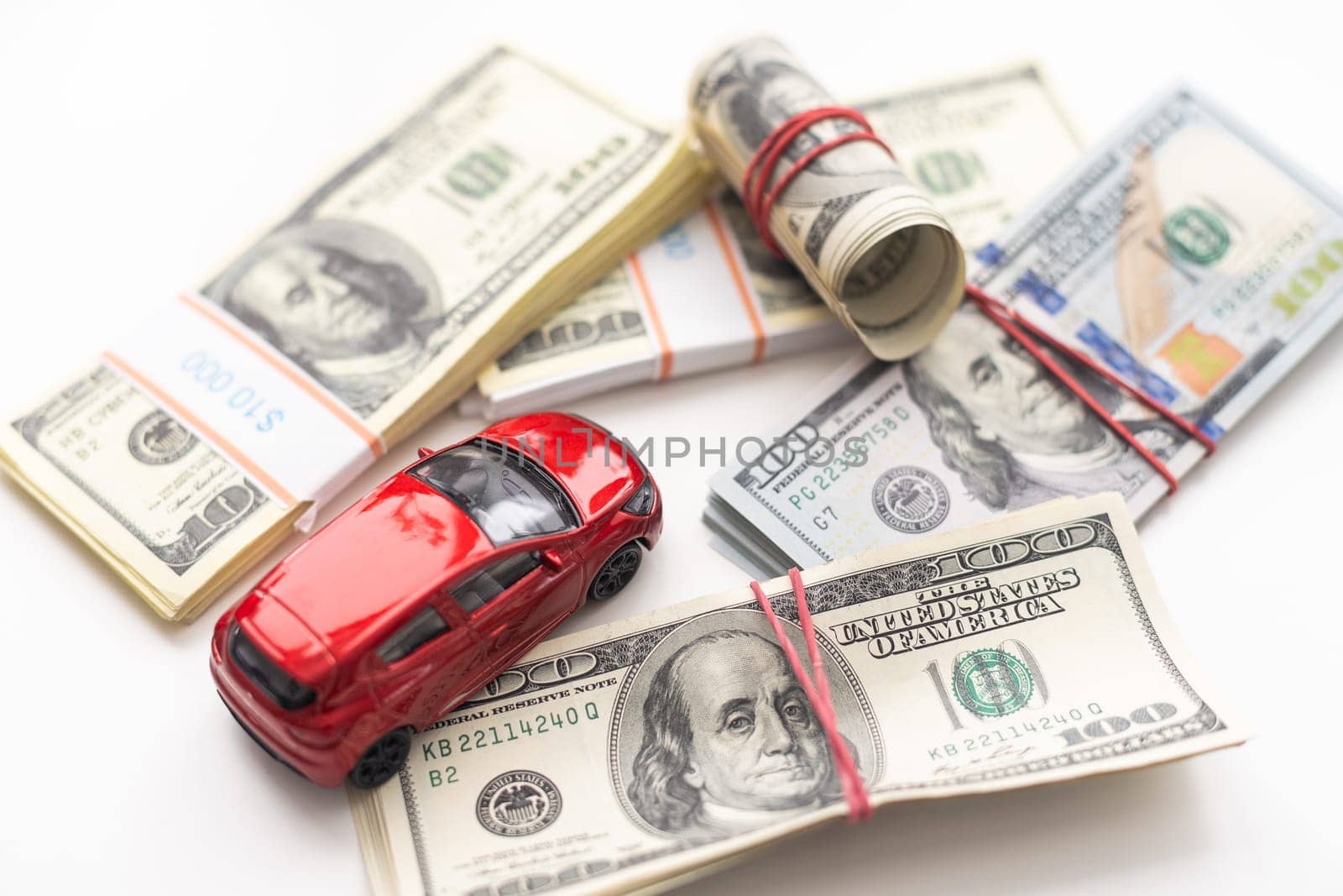 Small decorative car model, a lot of cash dollars of USA, credit for car concept. High quality photo