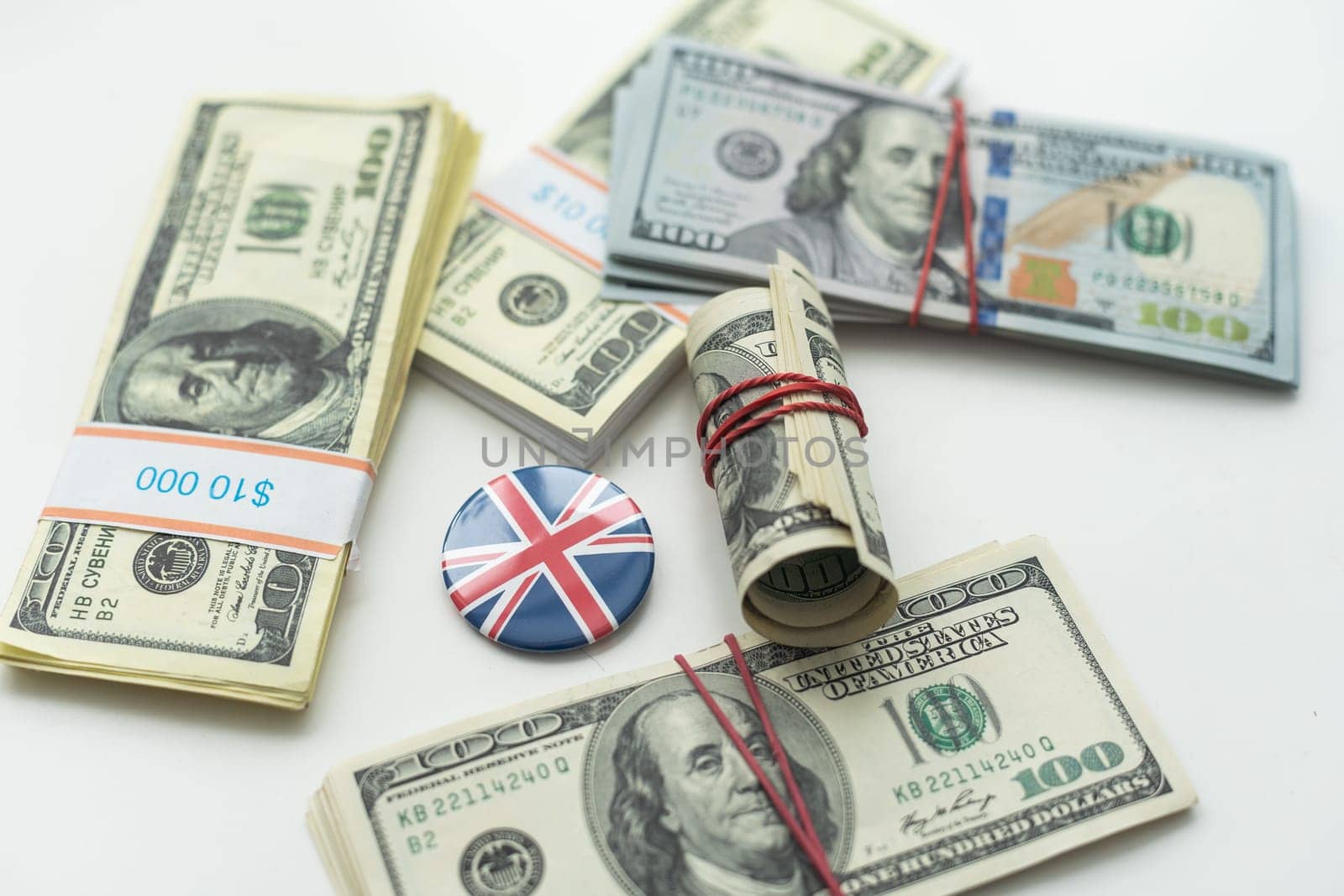 Cash money close up, top view. A bundle of 100 dollar bills lies on a pile of banknotes of various countries (dollars, euros, rubles). High quality photo
