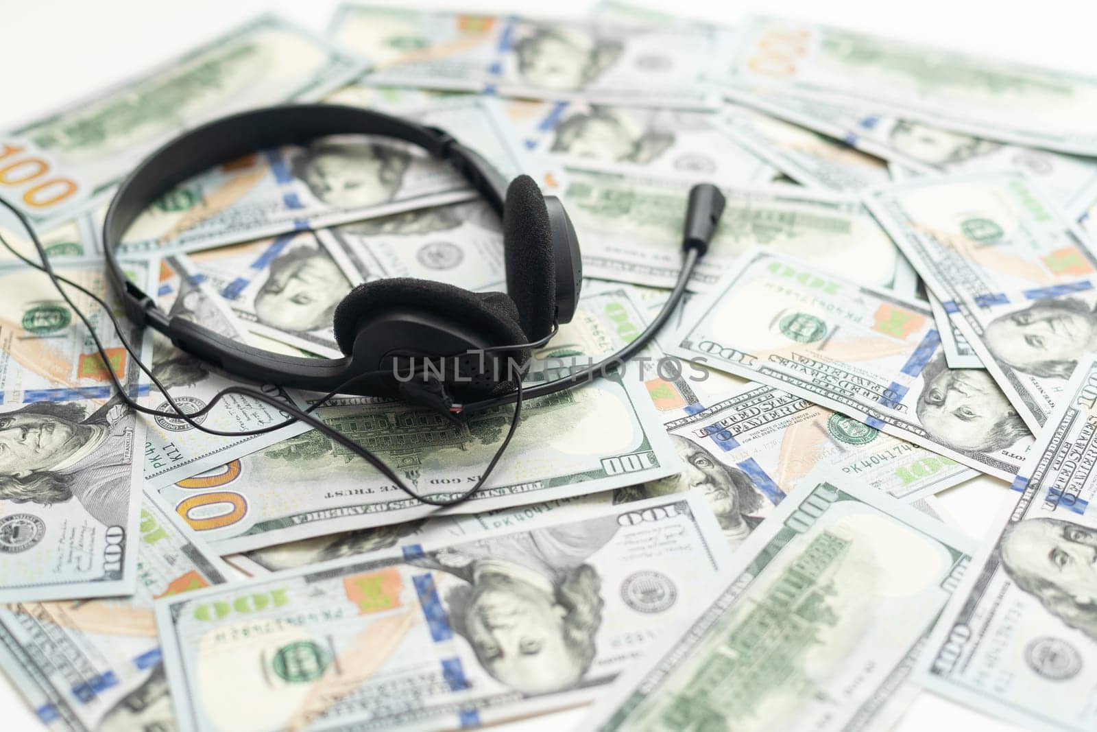 one hundred dollar bills and headphones. Close-up. High quality photo