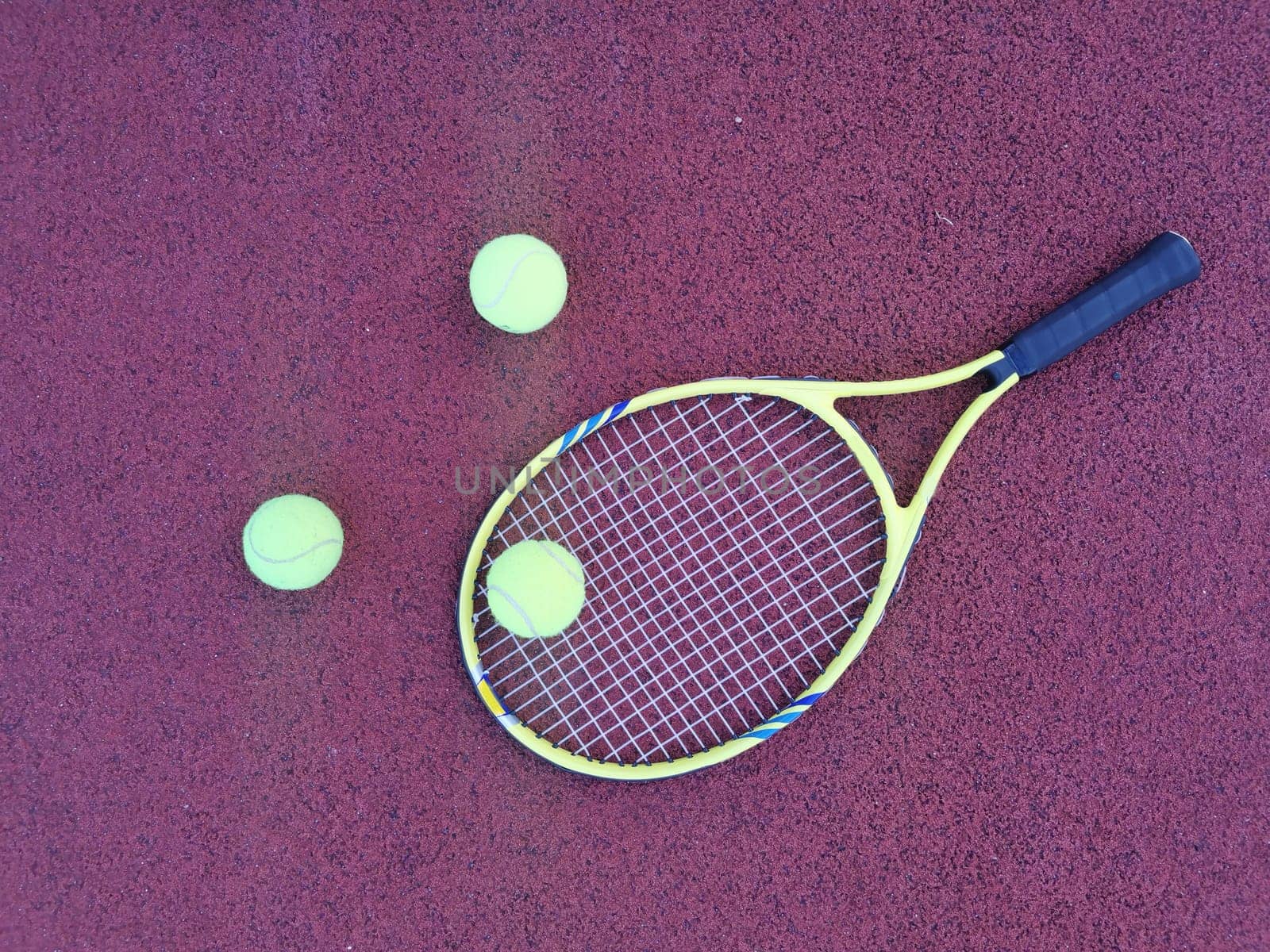 Tennis. Tennis ball and racket on a red background of tennis court with copy space. Sport and healthy lifestyle. The concept of outdoor game sports. . High quality photo