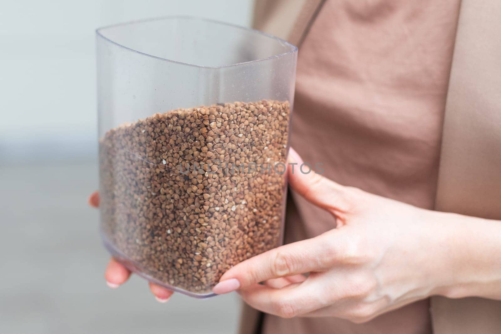 Hands holding buckwheat seeds, close-up . High quality photo