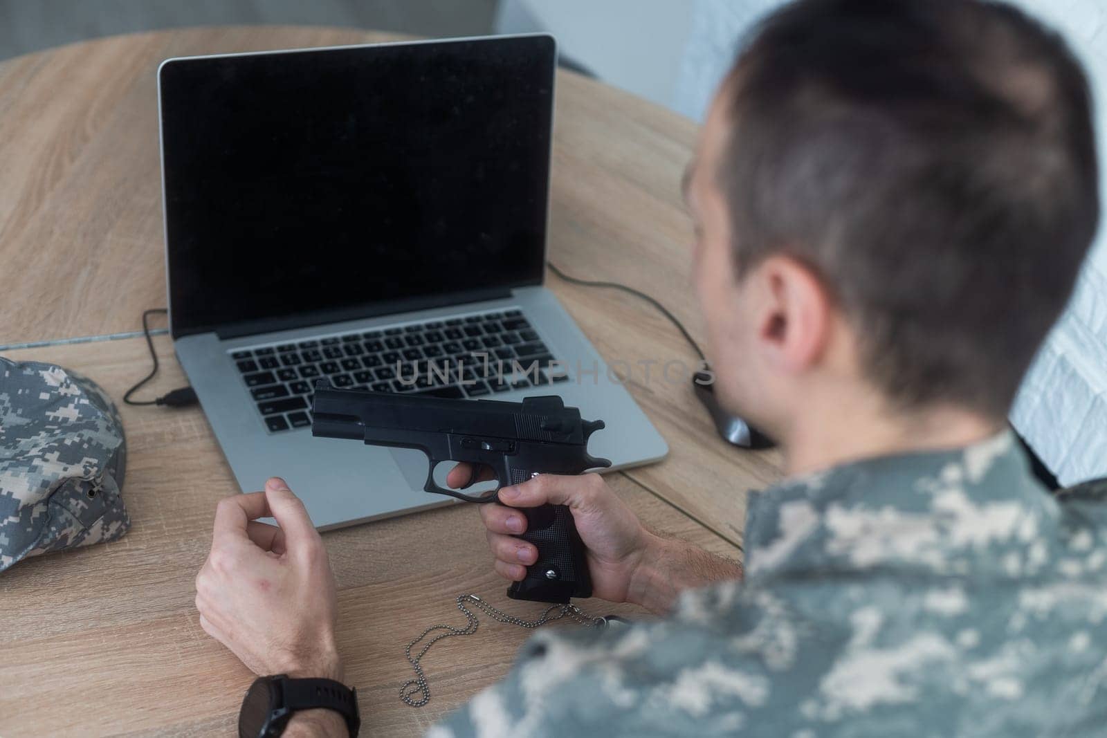 Portrait of young army soldier with a laptop. High quality photo