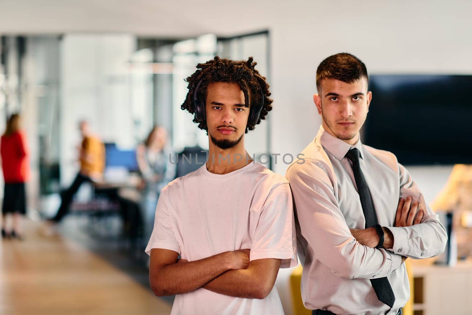 A group of colleagues, including an African American businessman and a young leader in a shirt and tie, pose together in a modern coworking center office, representing a dynamic blend of professionalism and collaboration by dotshock