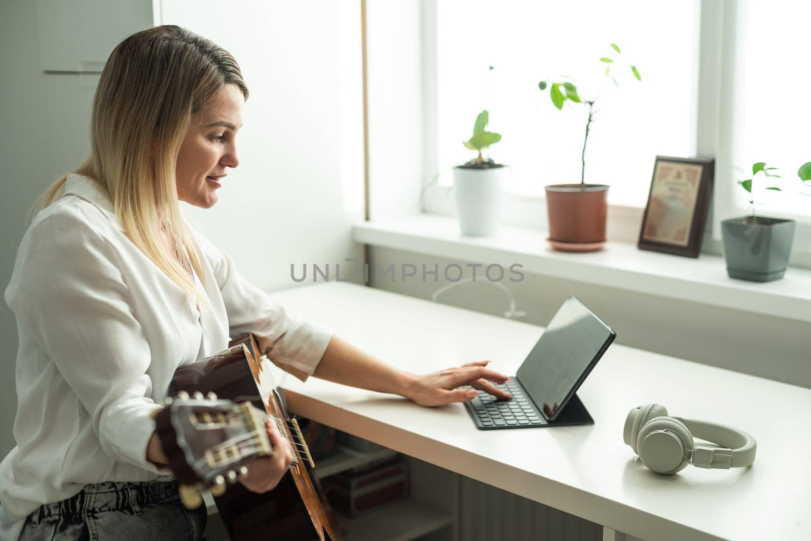 woman holding a guitar with her hands. High quality photo