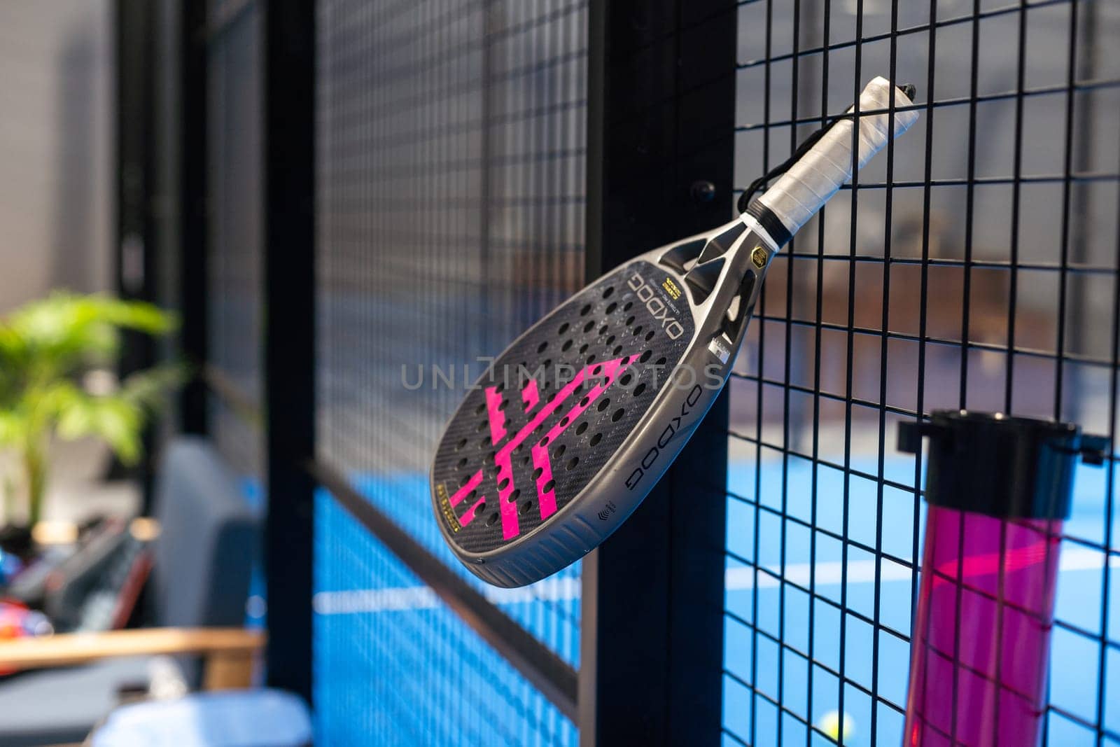 Ukraine Kyiv, April 02 2024. paddle tennis racket and balls on the blue paddle court. High quality photo
