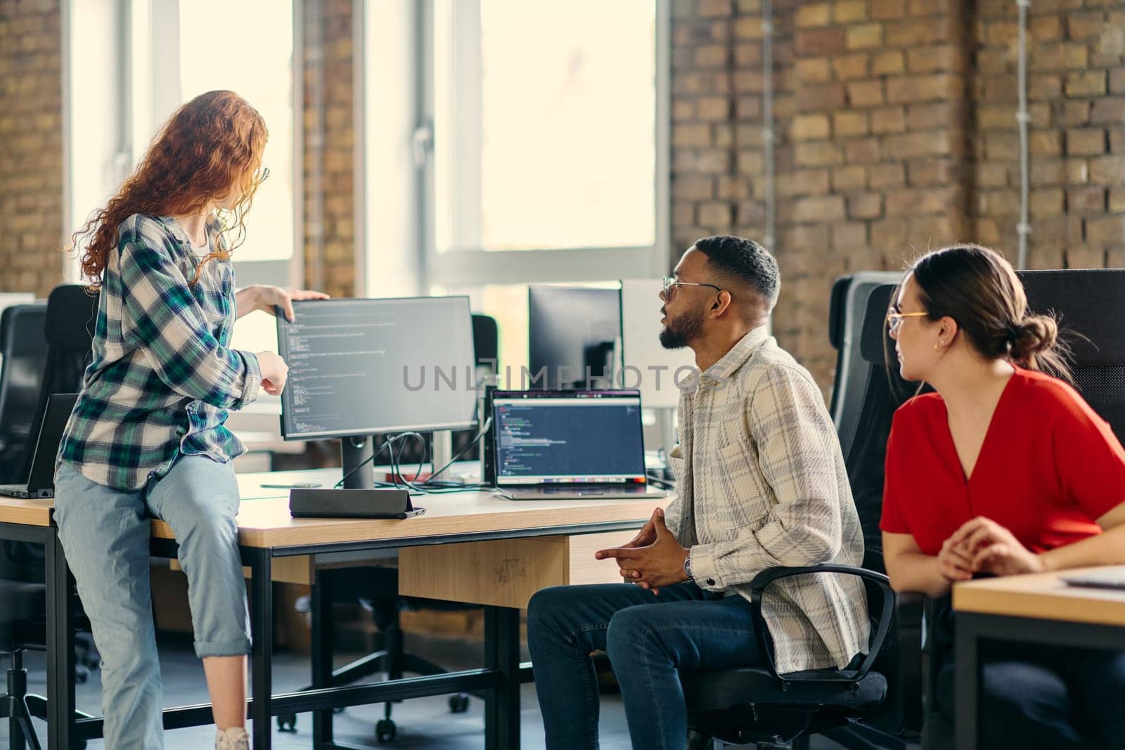 A diverse group of young business individuals congregates in a modern startup coworking center, embodying collaborative innovation and a dynamic atmosphere.