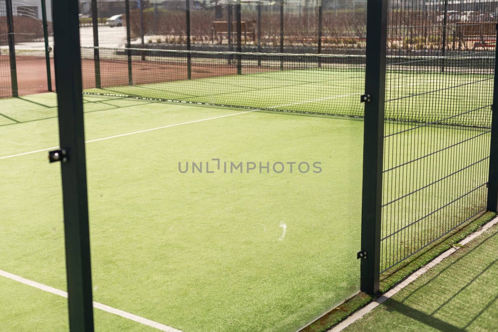 Tennis court with green grass and net outdoors. High quality photo