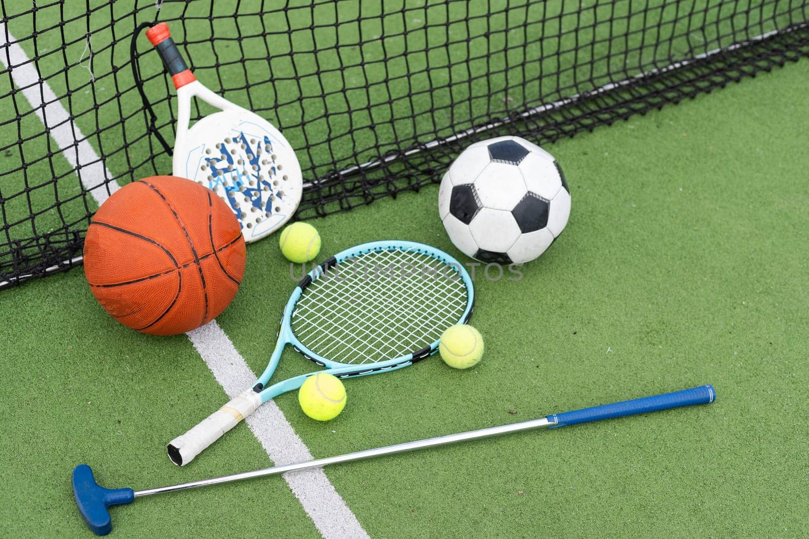 A group of sports equipment on background including tennis, basketball, and soccer on a background with copy space. High quality photo