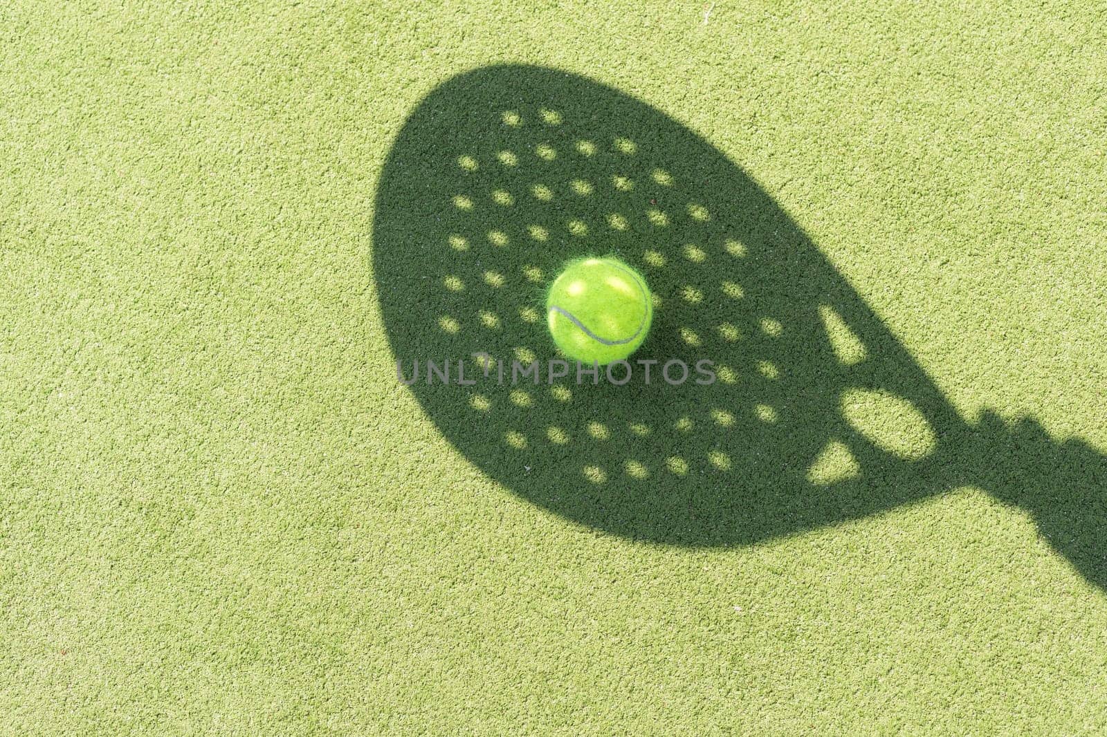 Paddle tennis racket shadow on balls. High quality photo