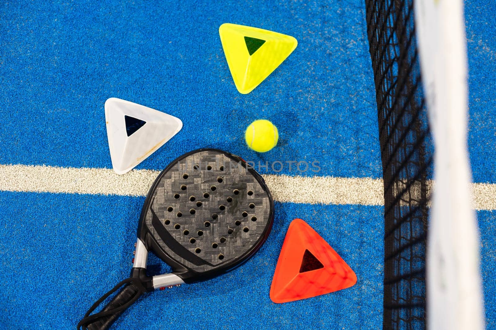 professional paddle tennis racket with natural lighting on blue background. Horizontal sport theme poster, greeting cards, headers, website and app. High quality photo