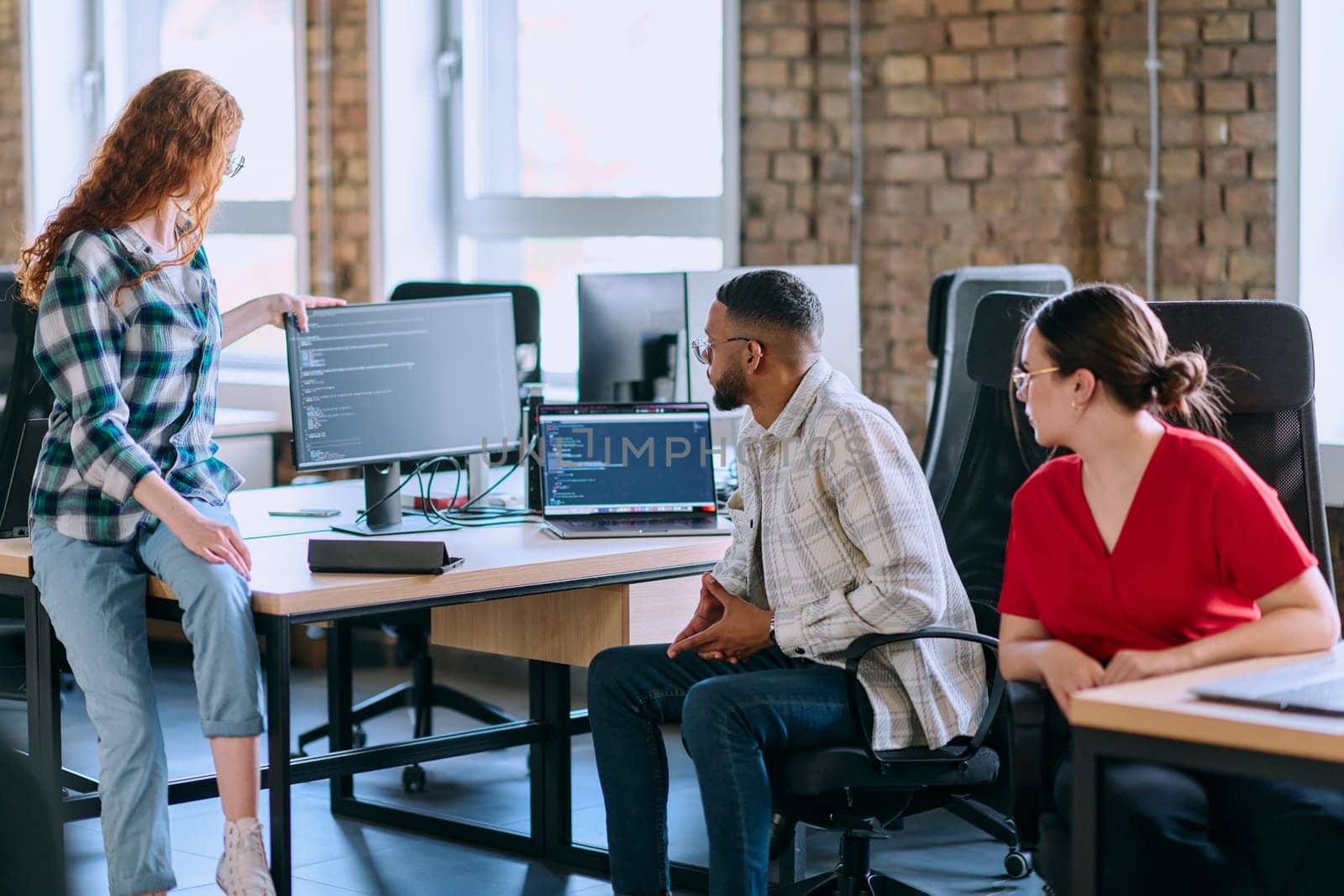 A diverse group of young business individuals congregates in a modern startup coworking center, embodying collaborative innovation and a dynamic atmosphere.