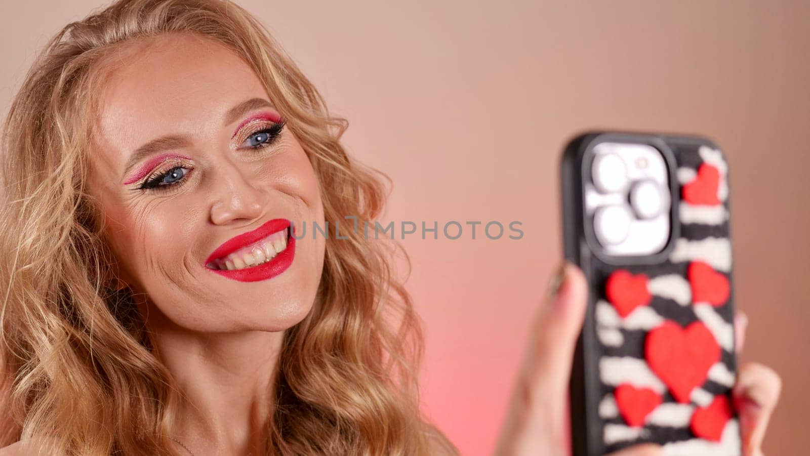 Blonde Woman with red lips Taking a Selfie by OksanaFedorchuk