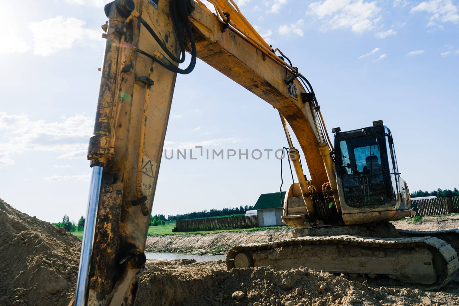 Excavator in quarry extracting stone, soil ground