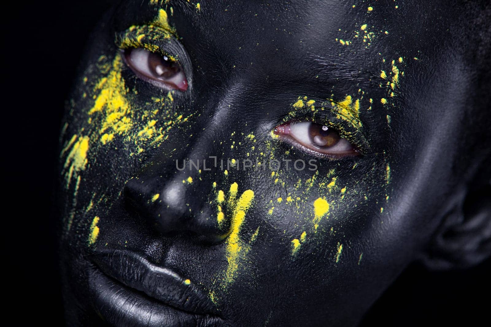 Art fashion makeup. An amazing woman with black makeup and leaking gold paint