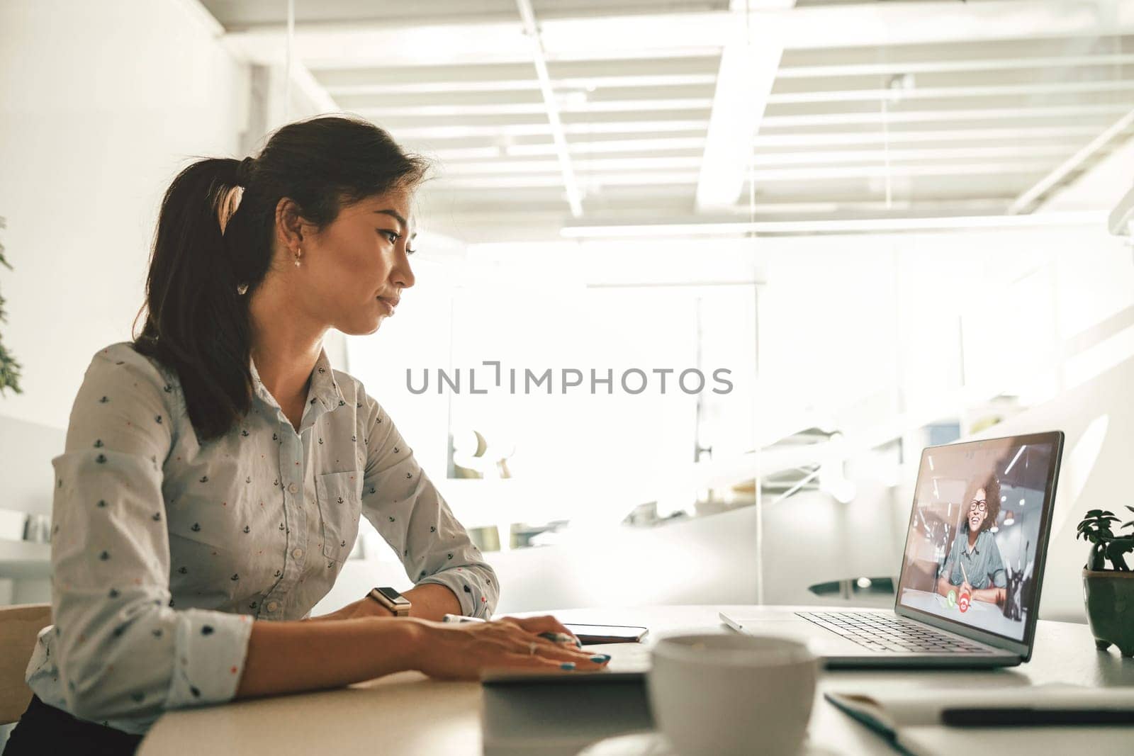 Businesswoman during online video conference with colleague in office. High quality photo