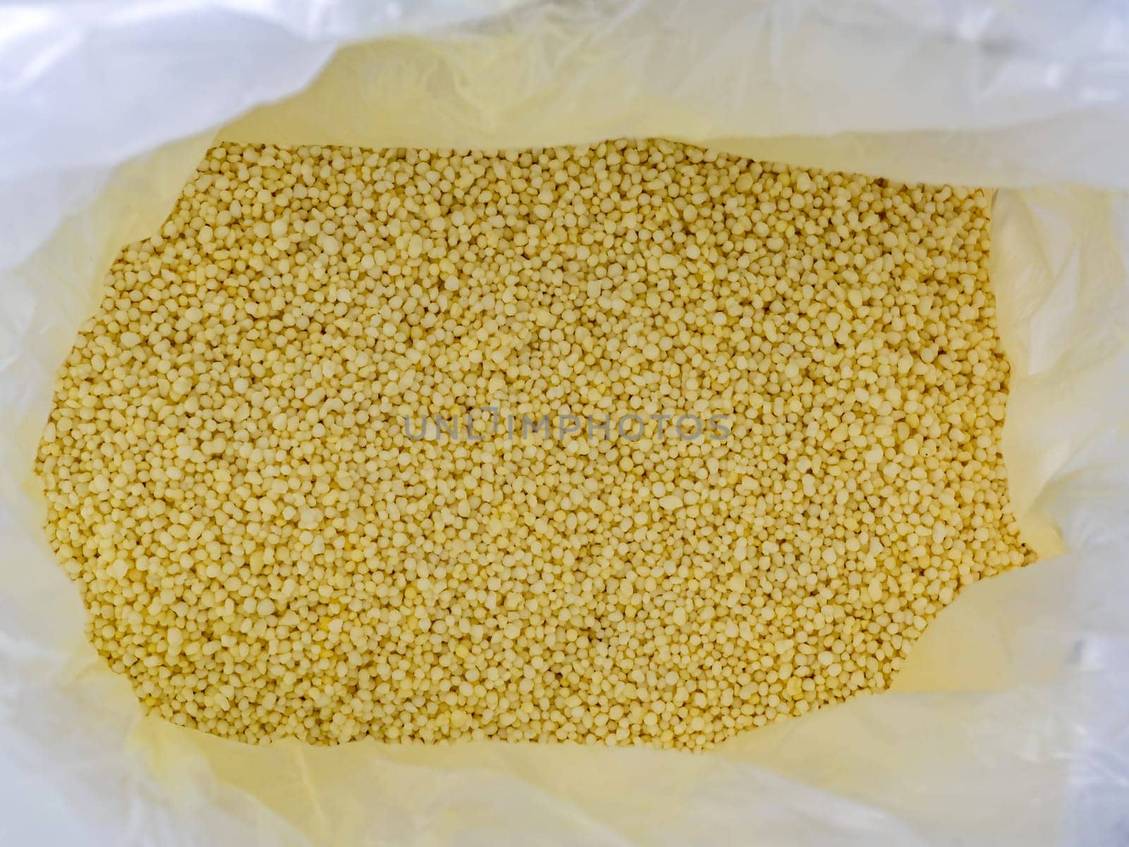Light yellow small round granules are chemical fertilizers, calcium nitrate by Satakorn