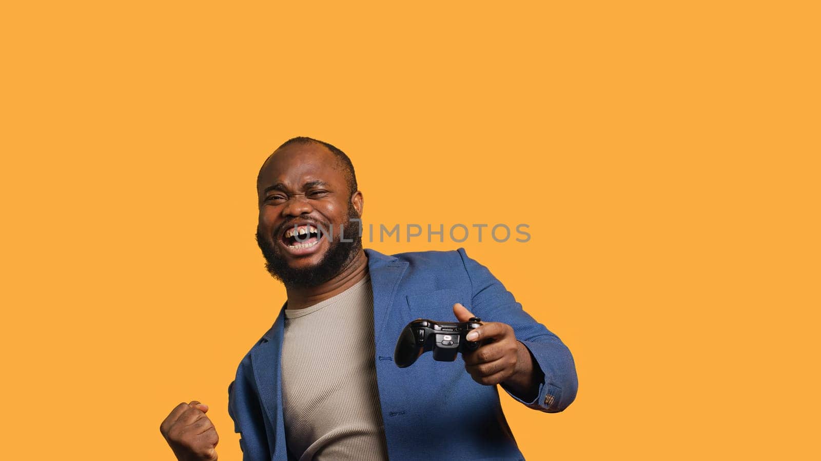 Delighted man bragging after being victorious in videogame, studio background by DCStudio