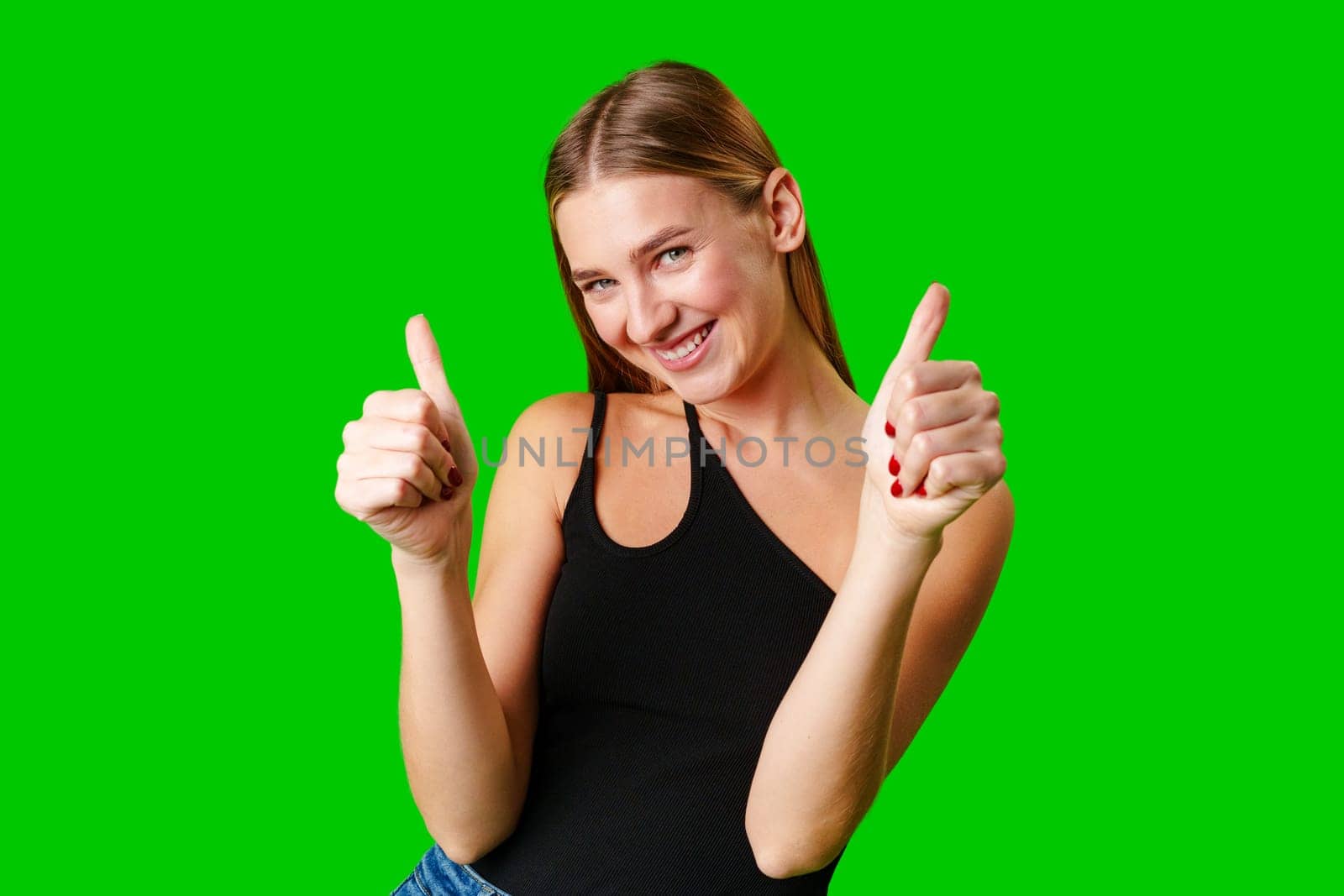 Young Woman Giving Thumbs Up Sign on Green Screen in studio