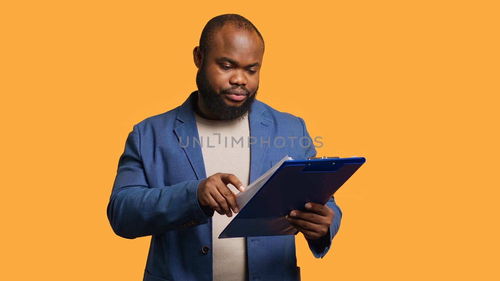 Man browsing though financial audit report on clipboard, yawning, feeling tired by DCStudio