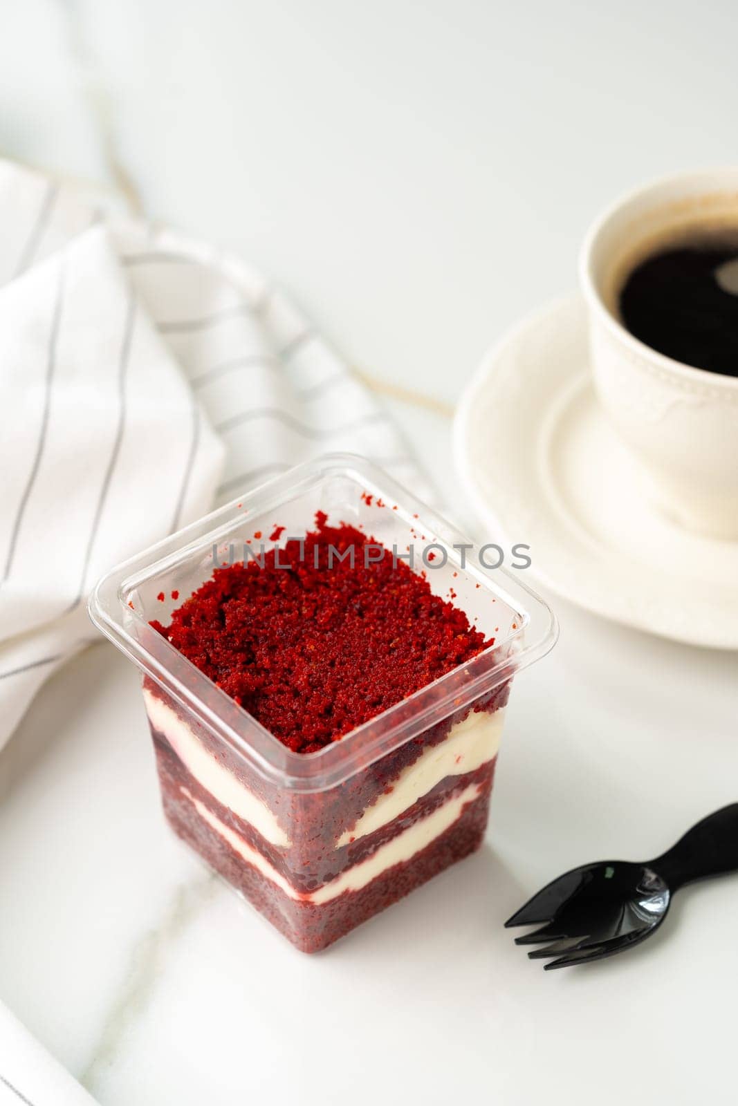 Trifle red velvet in plastic cup on table by Fabrikasimf