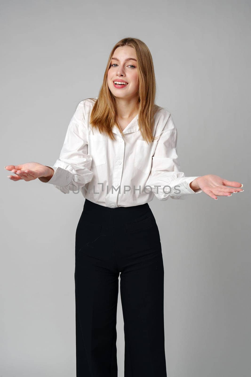 Woman in Formal Suit Holding Out Her Hands in studio