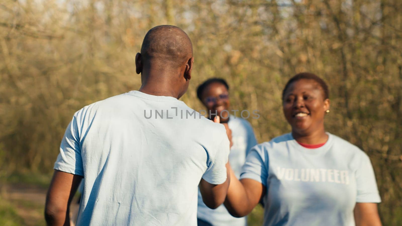 Cheerful people doing high five gesture with each other by DCStudio