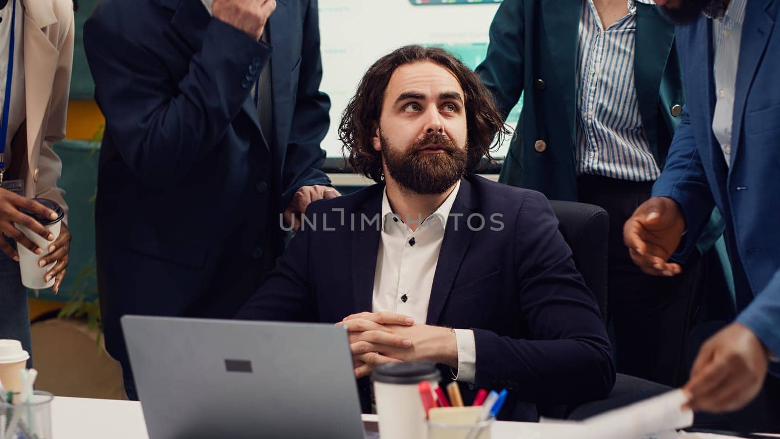 CEO examines what his employees accomplished with the new global development project, reading infographics and following revenue increase. Supervisor being proud of his team members. Camera A.