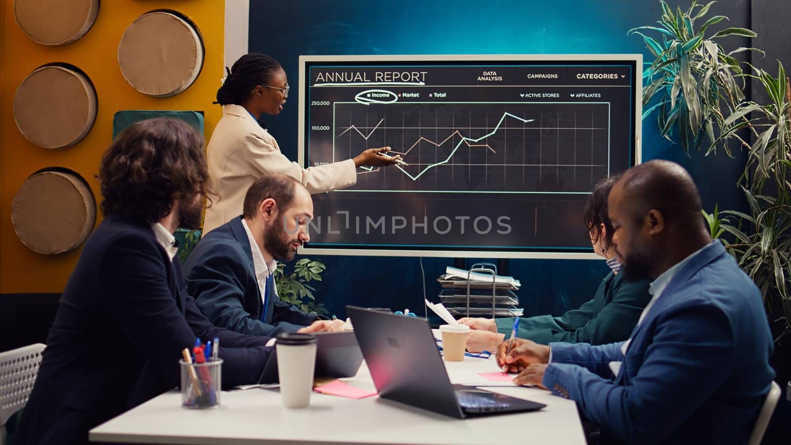 Startup team reviewing annual reports infographics on interactive board, studying market entry approaches and demands to facilitate global growth. Business employees accomplish goals. Camera B.