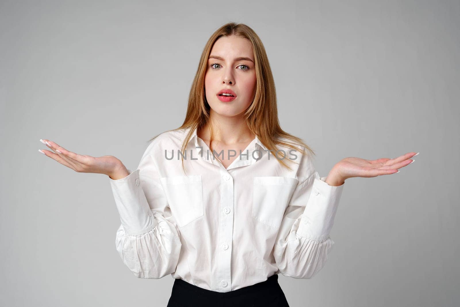 Woman in Formal Suit Holding Out Her Hands in studio