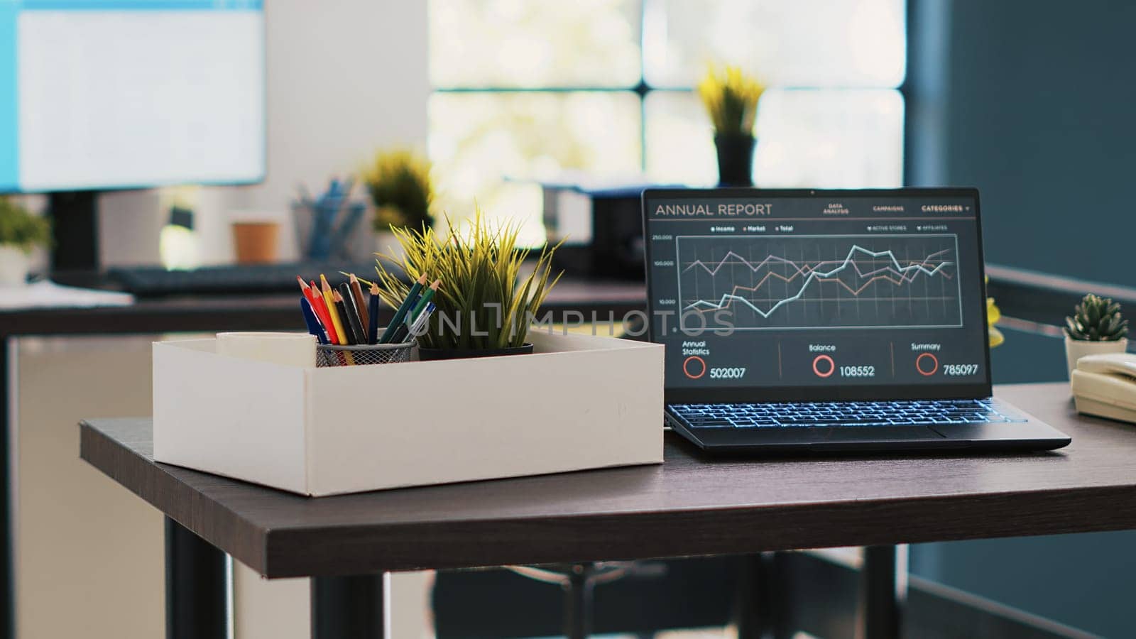 Business forecasting graphs showing profits on laptop in empty office. Economic annual revenue statistics report on notebook screen in accounting department office with no people in