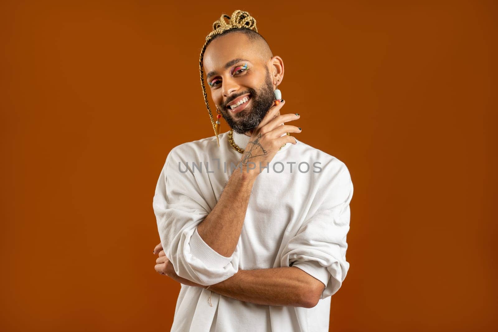 Make up artist Black latin gay man isolated on orange background by andreonegin