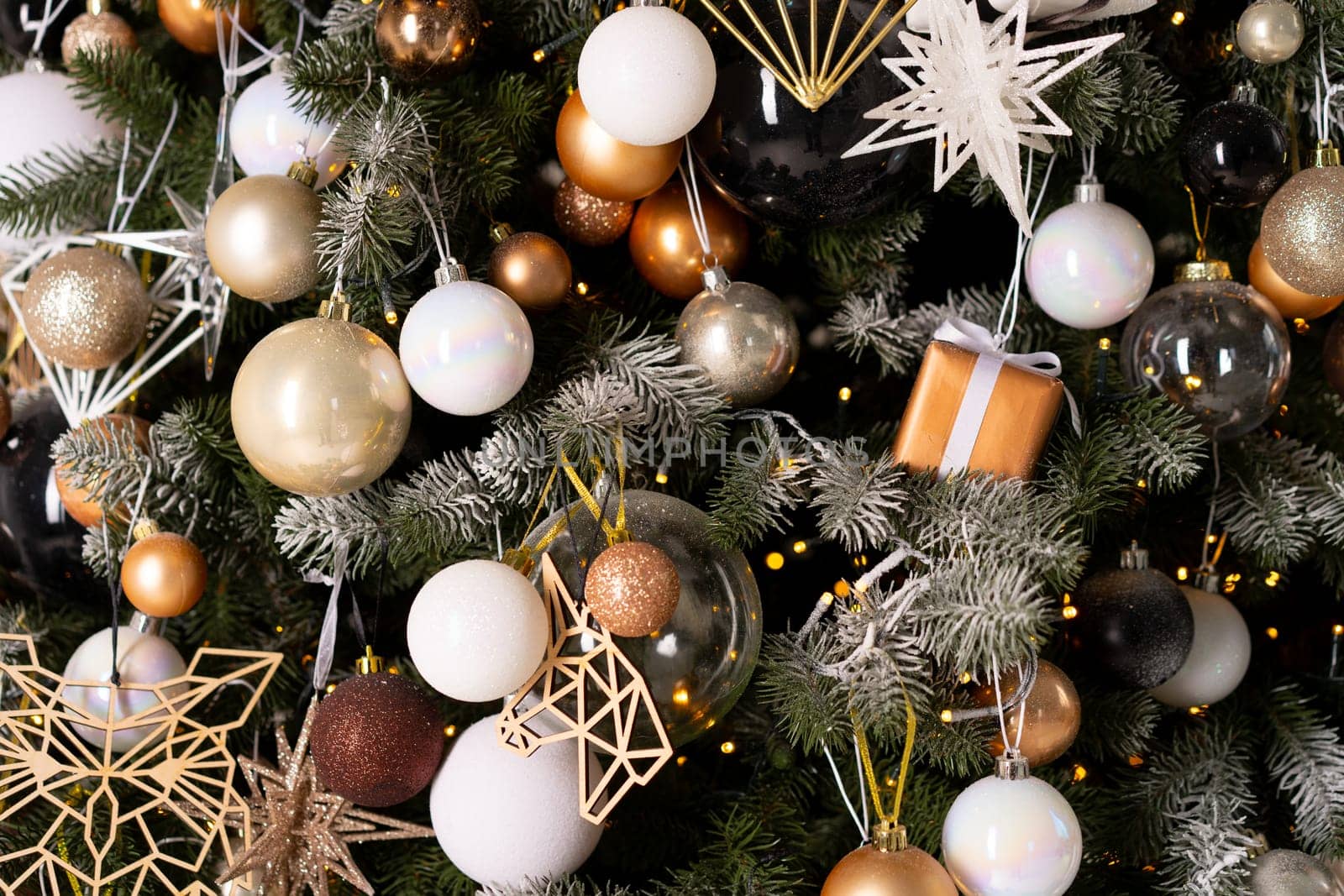 Christmas tree decoration close up background. Garland, balls, illuminated lights by andreonegin