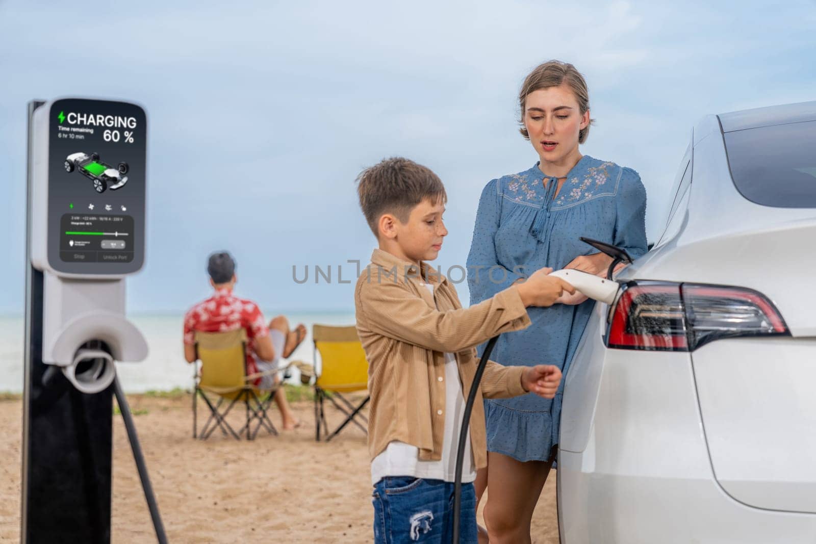 Family vacation trip traveling by the beach with electric car, lovely family recharge EV car with green and sustainable energy. Seascape travel and eco-friendly car for clean environment. Perpetual