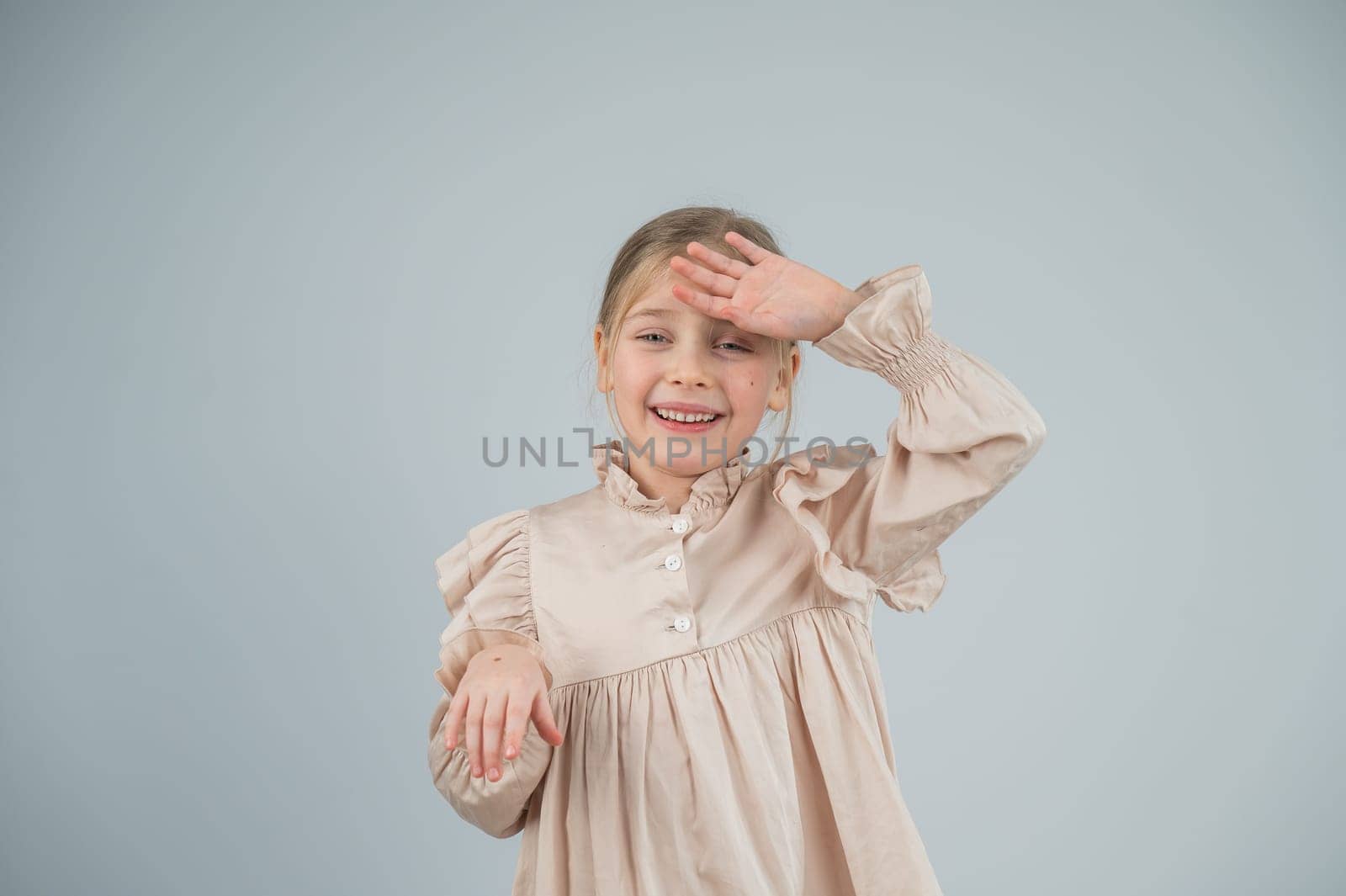 Little Caucasian girl having fun and making faces on a white background. by mrwed54