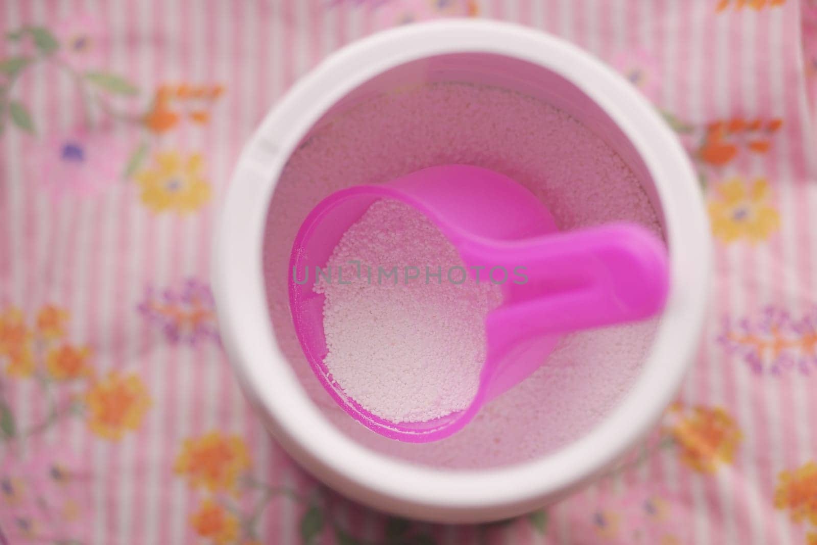 Washing powder in plastic spoon on blue background by towfiq007