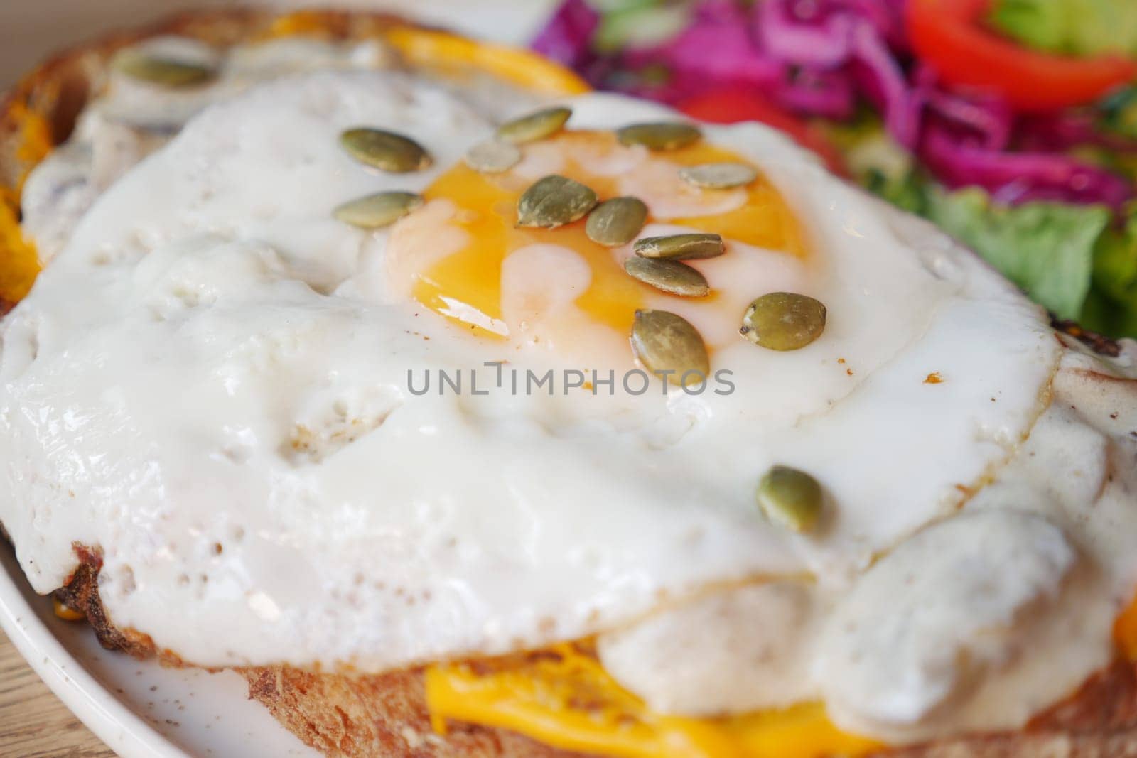 closeup of fried egg on toast. by towfiq007