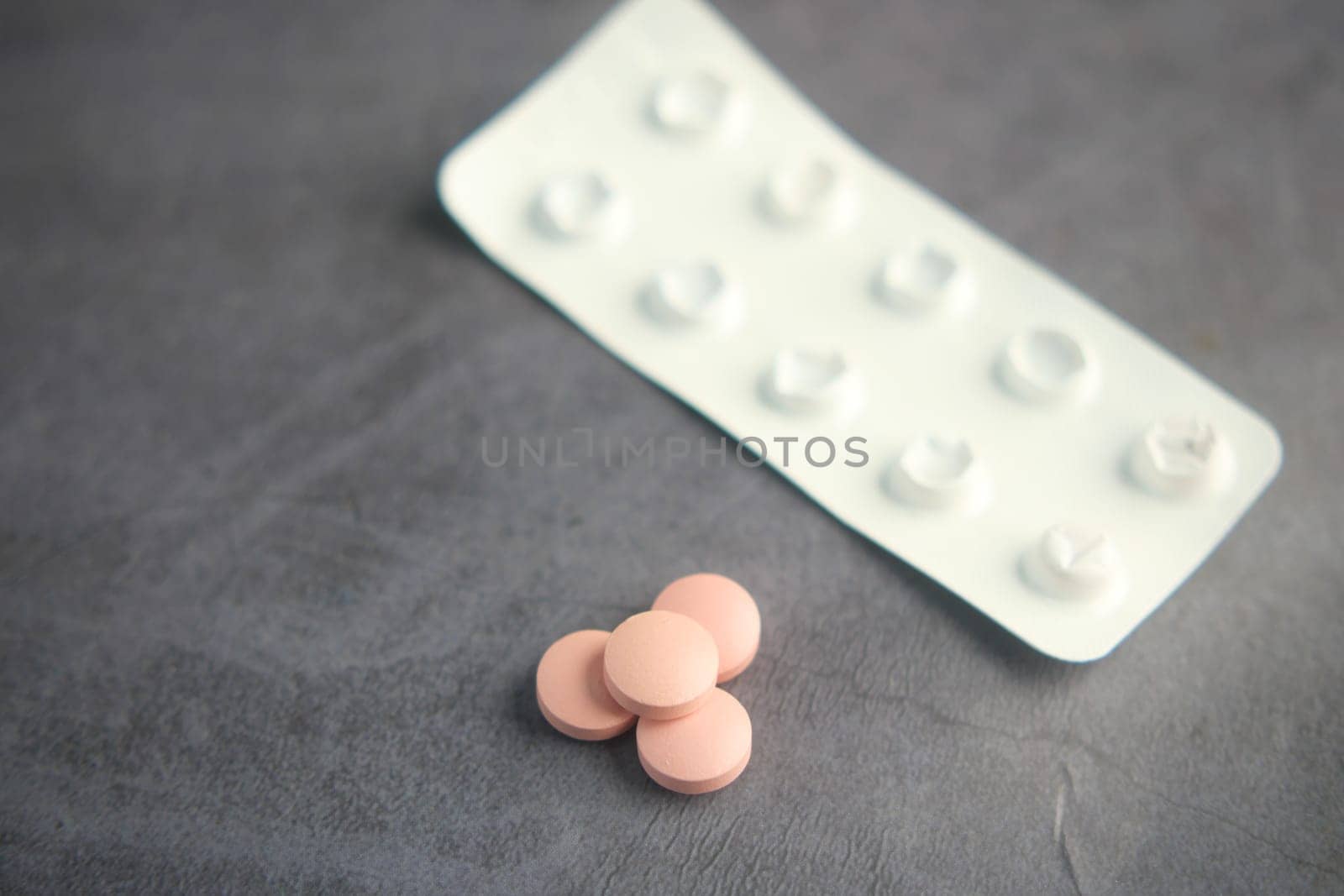 Close up of pills of blister pack on table .