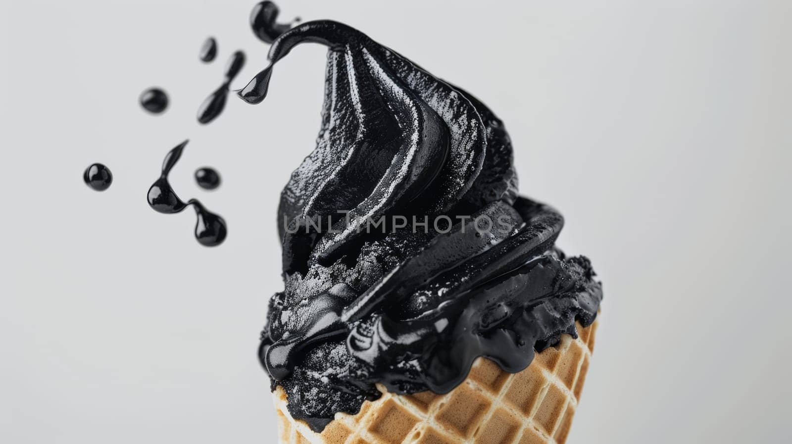 Black ice cream in waffles cone on white background.