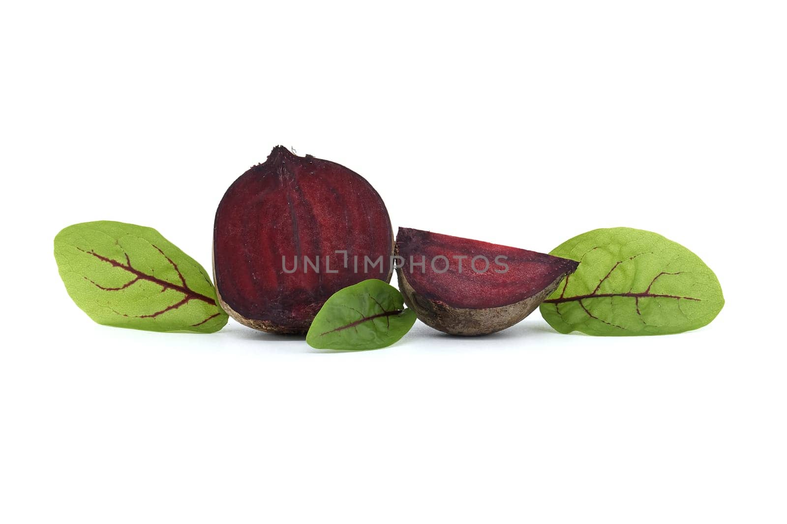 Slices of beetroot and fresh green leaves isolated on white by NetPix