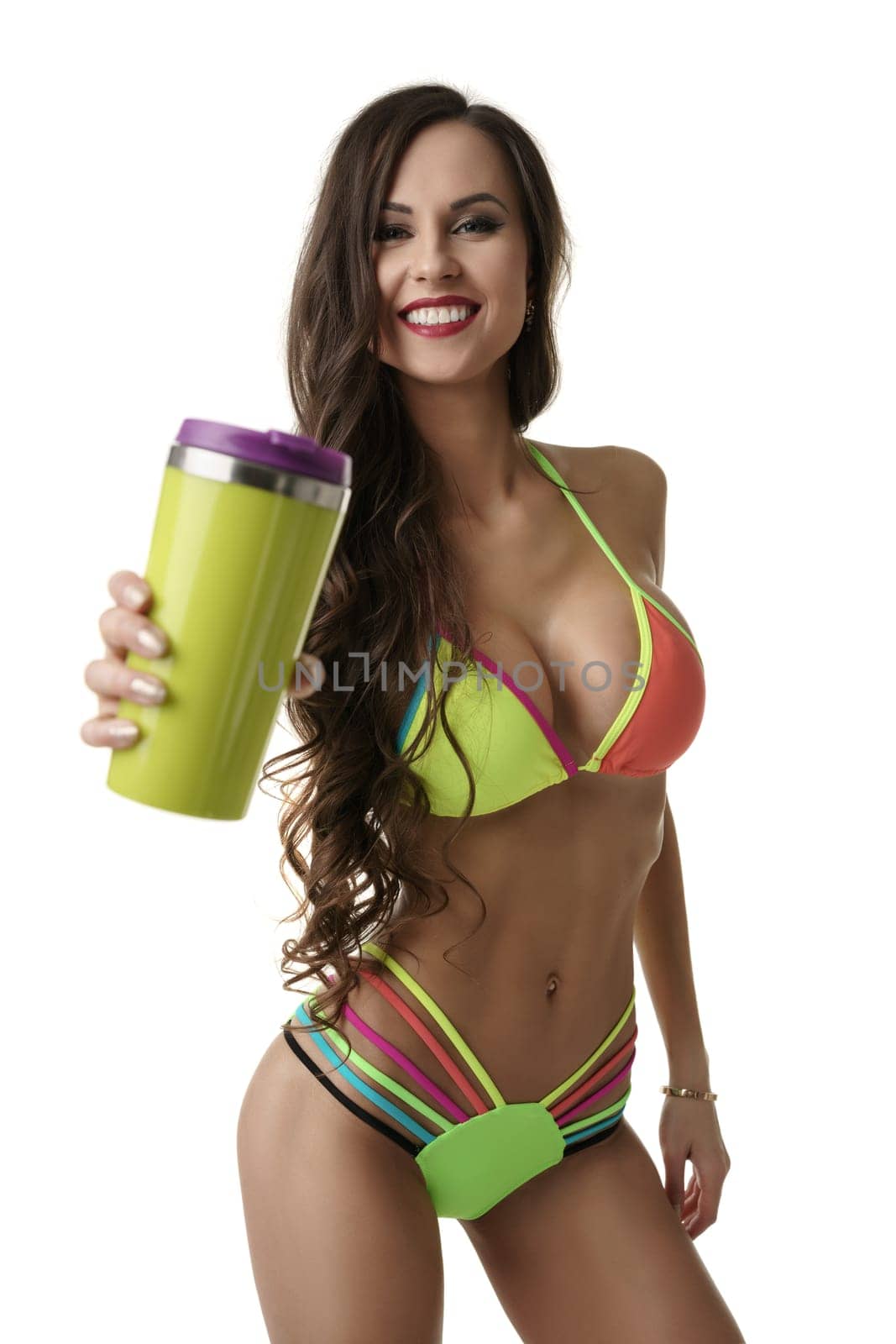 Sexy girl in bright lingerie with a nice yellow sport water container in her hand standing in in flirtatious pose.