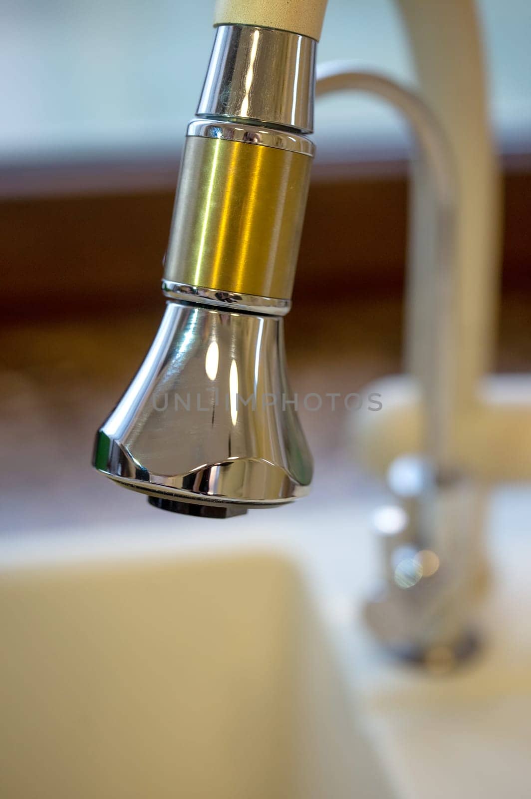 faucet in the sink in the kitchen close-up. by Pukhovskiy