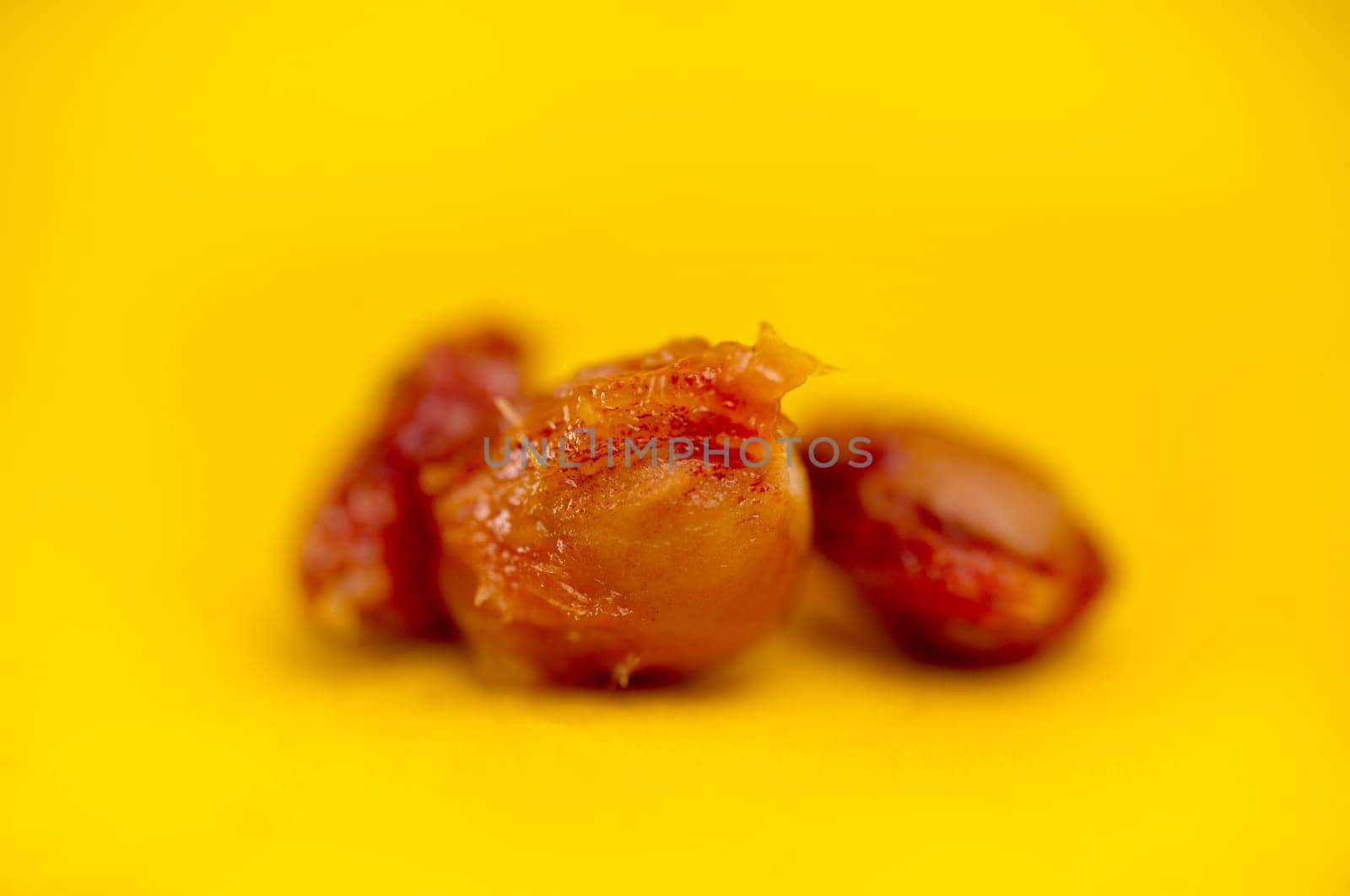 cherry pits, fruit pits on a yellow background.