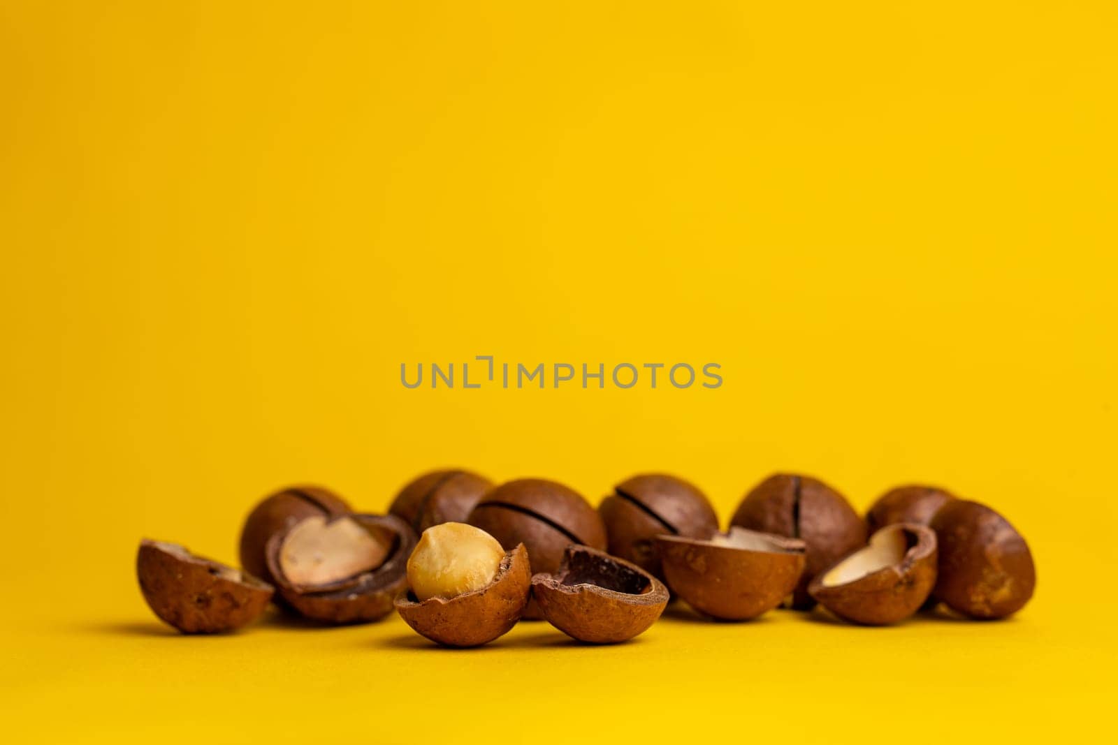 the most delicious macadamia nut on a yellow background by Pukhovskiy